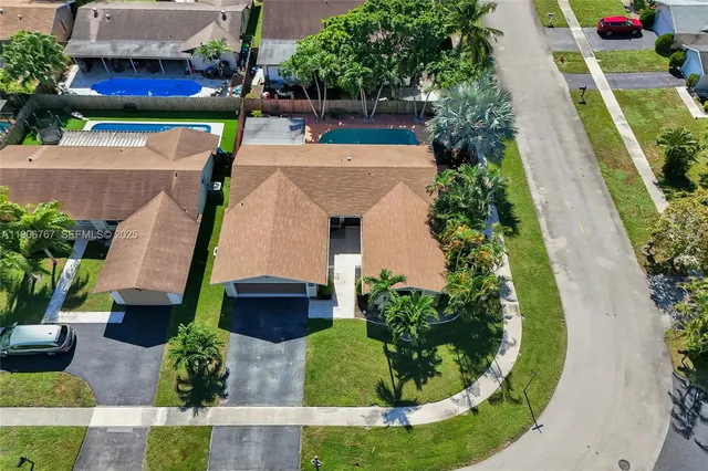 an aerial view of a house with a garden and plants