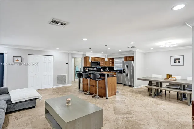 a living room with lots of furniture and kitchen view