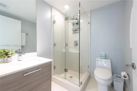 a bathroom with a sink toilet and shower