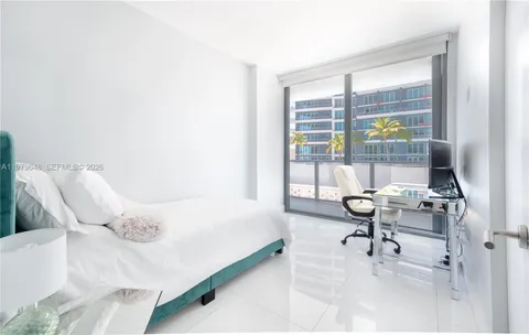 a bedroom with a bed and a desk