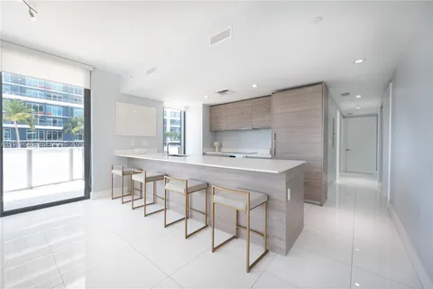 a kitchen with stainless steel appliances a sink and a refrigerator