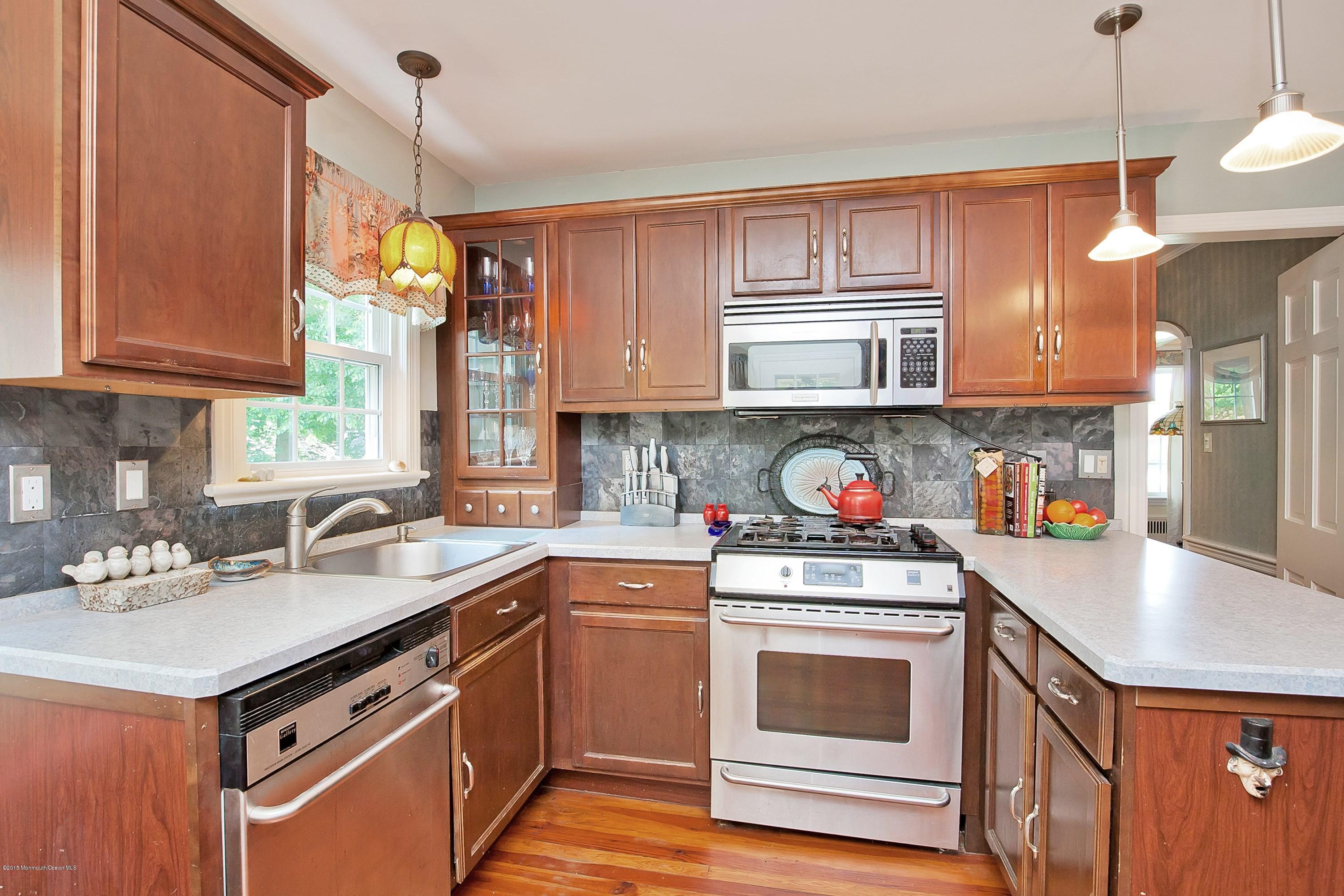 157 Harding Road Red Bank, NJ 07701 - Photo 8 of 37 a kitchen with stainless steel appliances granite countertop a sink stove and cabinets