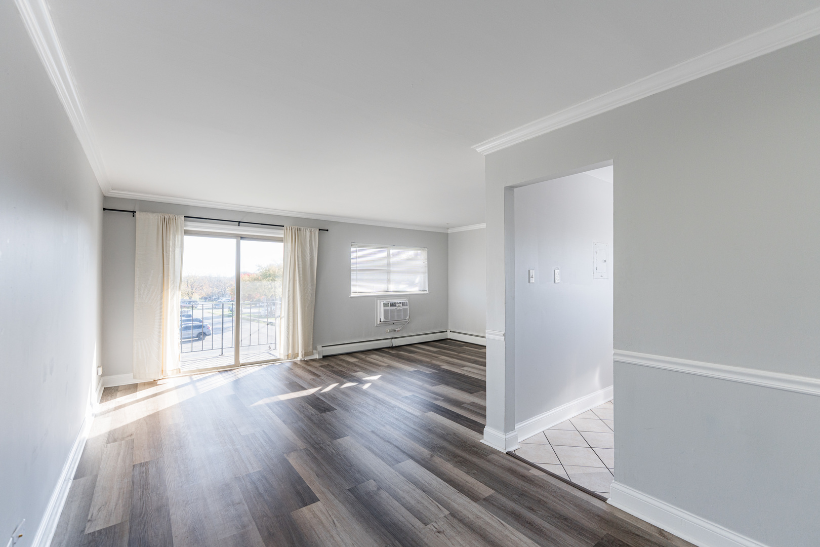 680 Marilyn Avenue, Unit 6206 Glendale Heights, IL 60139 - Photo 4 of 18 an empty room with wooden floor and windows