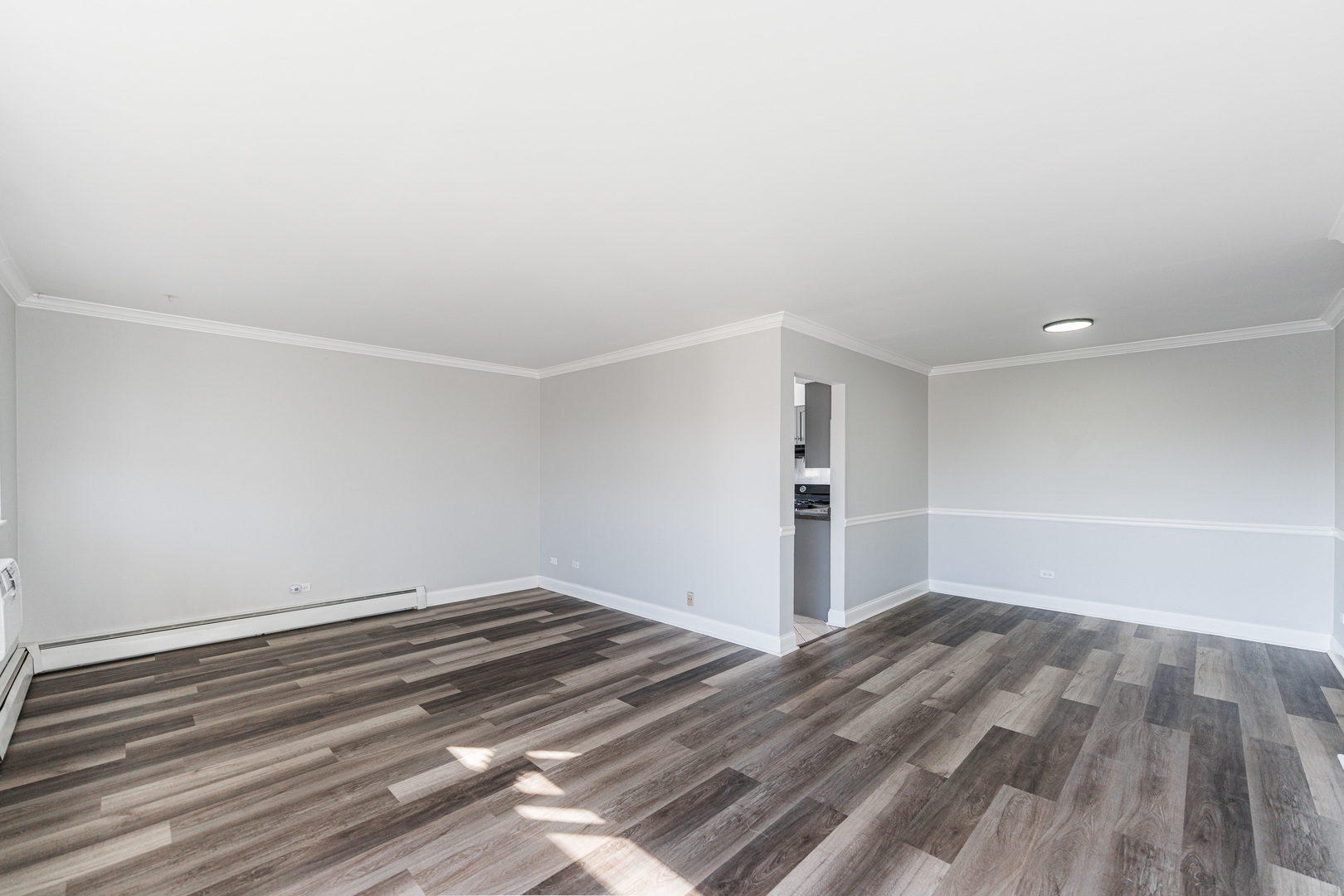 680 Marilyn Avenue, Unit 6206 Glendale Heights, IL 60139 - Photo 6 of 18 a view of a room with wooden floor and white walls