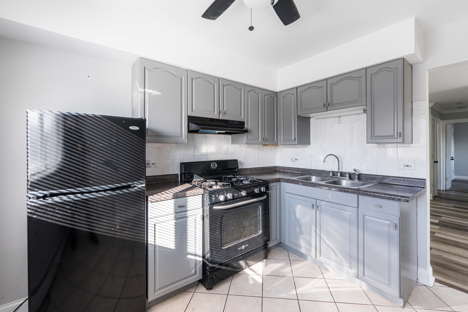 680 Marilyn Avenue, Unit 6206 Glendale Heights, IL 60139 - Photo 8 of 18 a kitchen with granite countertop a stove sink and cabinets