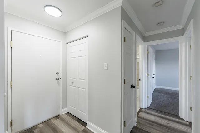 a view of a hallway with wooden floor and staircase