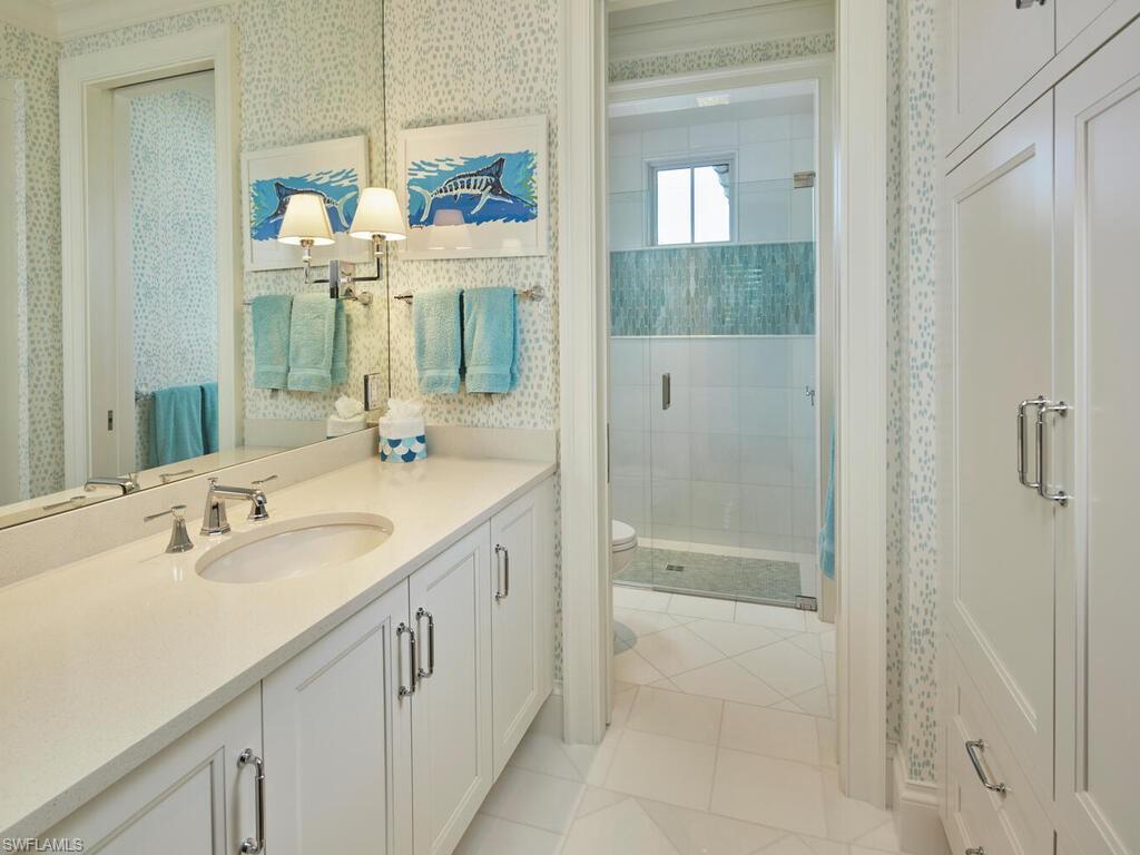 167 4th Street North Naples, FL 34102 - Photo 20 of 33 a bathroom with a double vanity sink mirror and shower