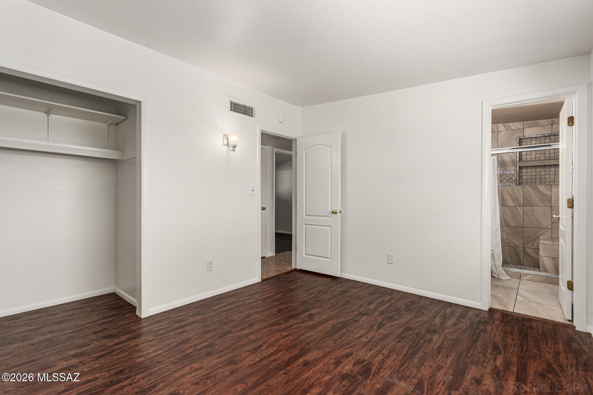 17 East Los Reales Road Tucson, AZ 85756 - Photo 12 of 27 a view of an empty room with wooden floor and a window