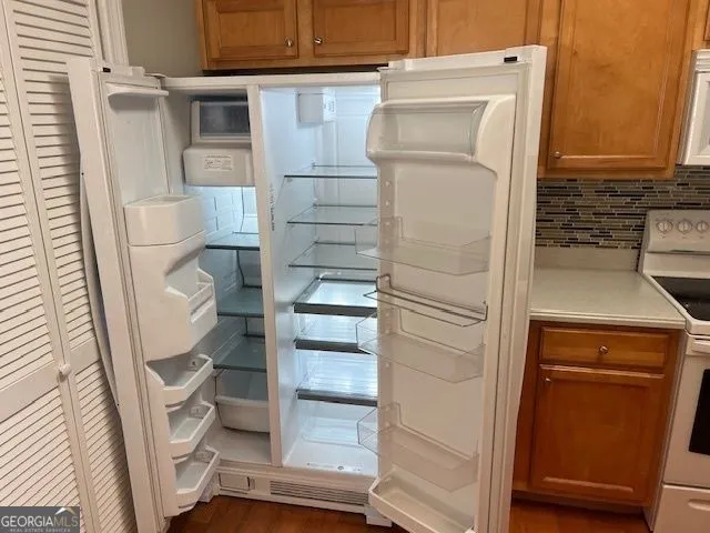a bathroom with a refrigerator and a sink