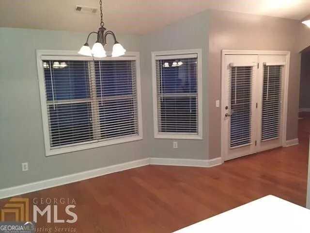 a view of an empty room with windows