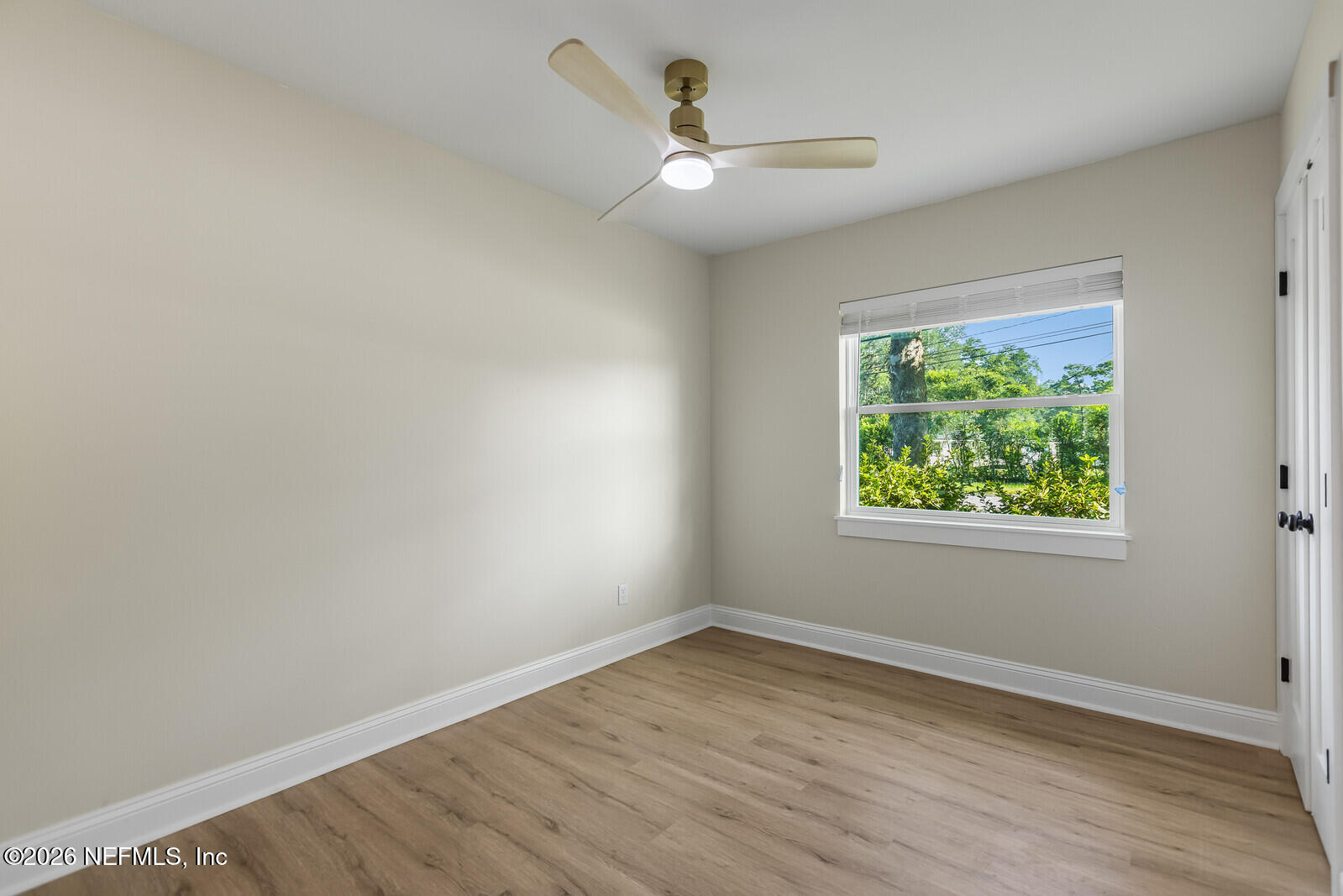 2614 Leonid Road Jacksonville, FL 32218 - Photo 14 of 24 an empty room with wooden floor and windows