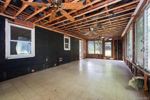 a view of an empty room with windows