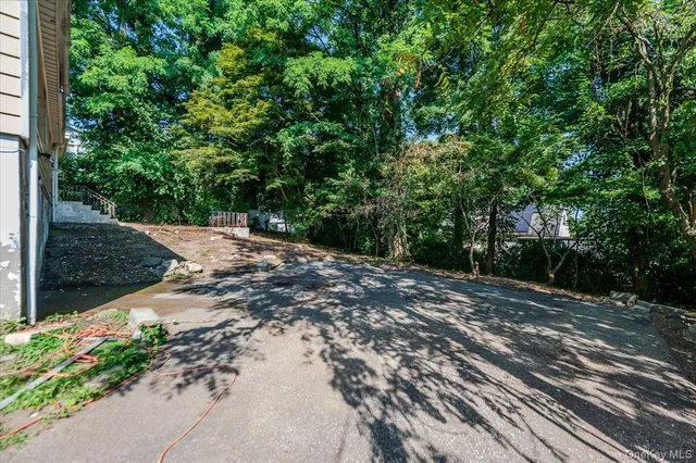 a front view of a house with yard and green space