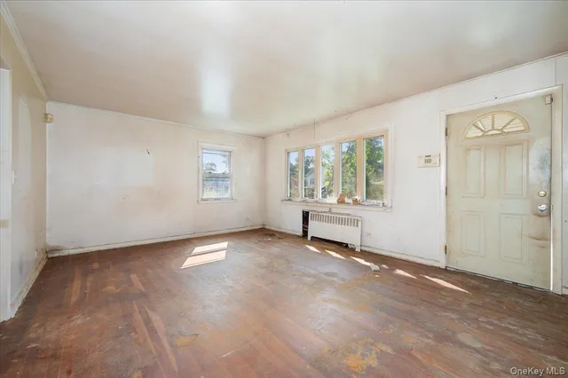 an empty room with windows and closet