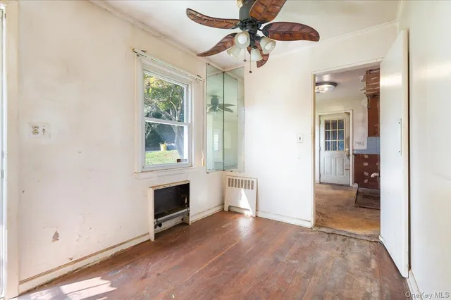 wooden floor in an empty room with a window