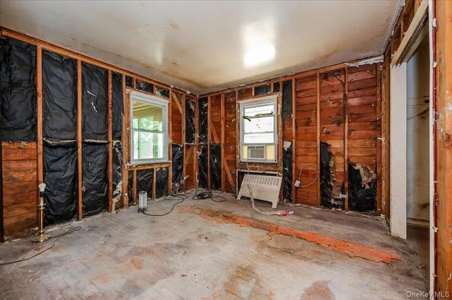 an empty room with furniture and a window