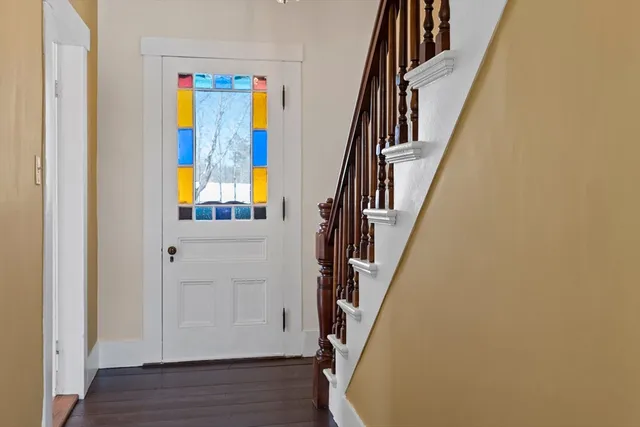 a view of front door with wooden floor