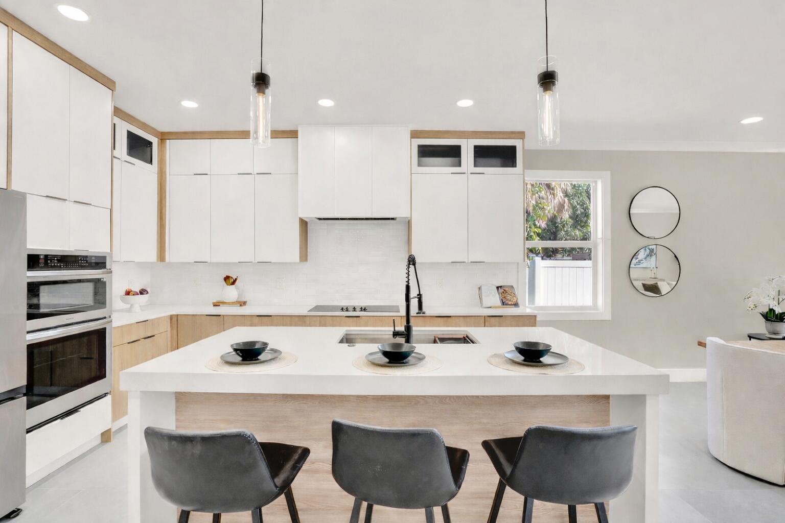 18 Southwest 6th Street Delray Beach, FL 33444 - Photo 13 of 40 a kitchen with a dining table chairs sink and white stove