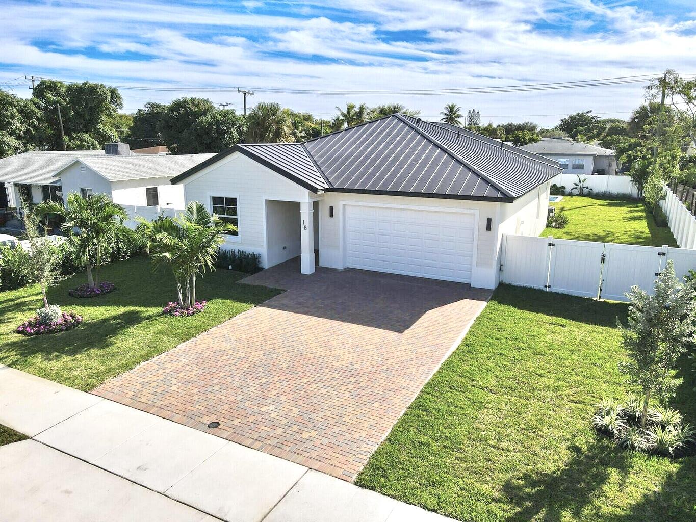 18 Southwest 6th Street Delray Beach, FL 33444 - Photo 31 of 40 a front view of house with yard and trees in the background