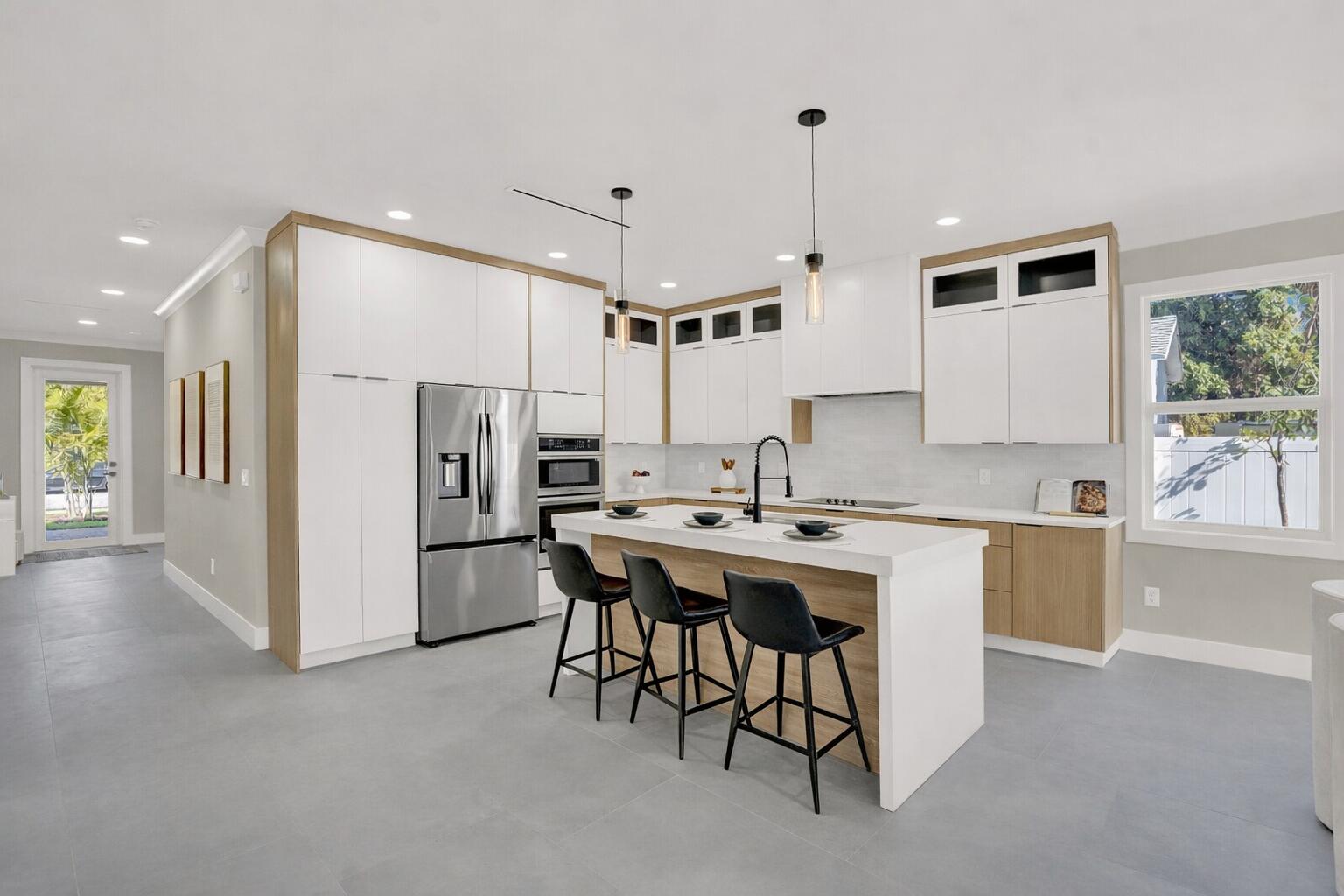 18 Southwest 6th Street Delray Beach, FL 33444 - Photo 7 of 40 a kitchen with refrigerator and cabinets