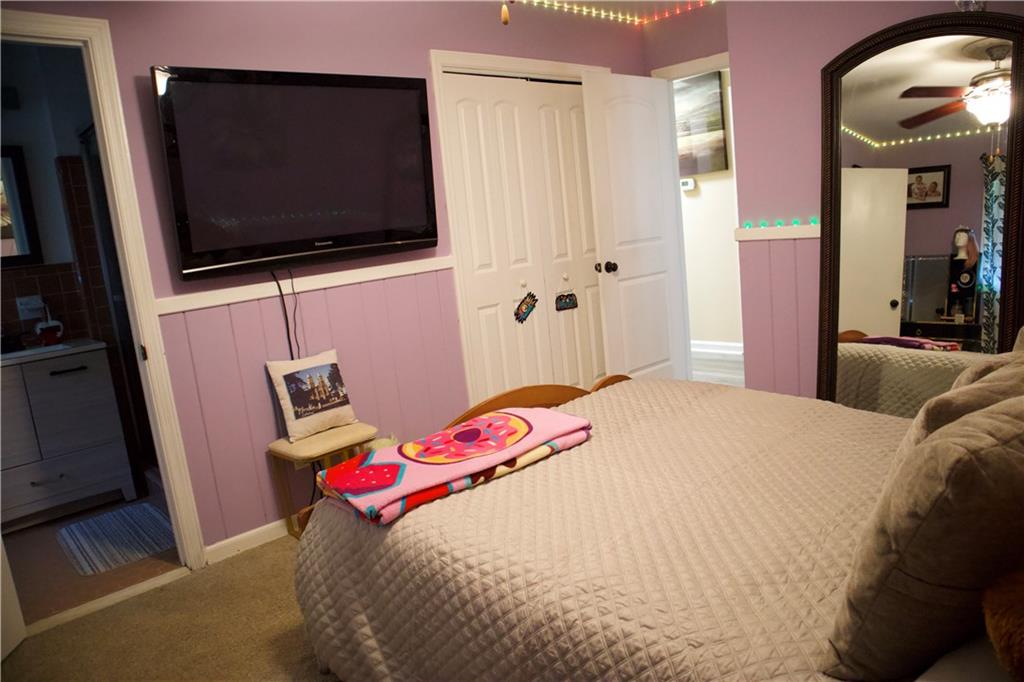 2586 Brandon Road Atlanta, GA 30337 - Photo 17 of 24 a bedroom with a bed and a flat screen tv