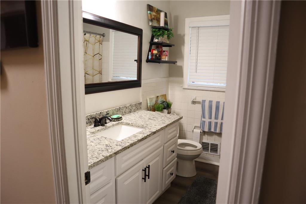 2586 Brandon Road Atlanta, GA 30337 - Photo 19 of 24 a bathroom with a granite countertop toilet sink and mirror