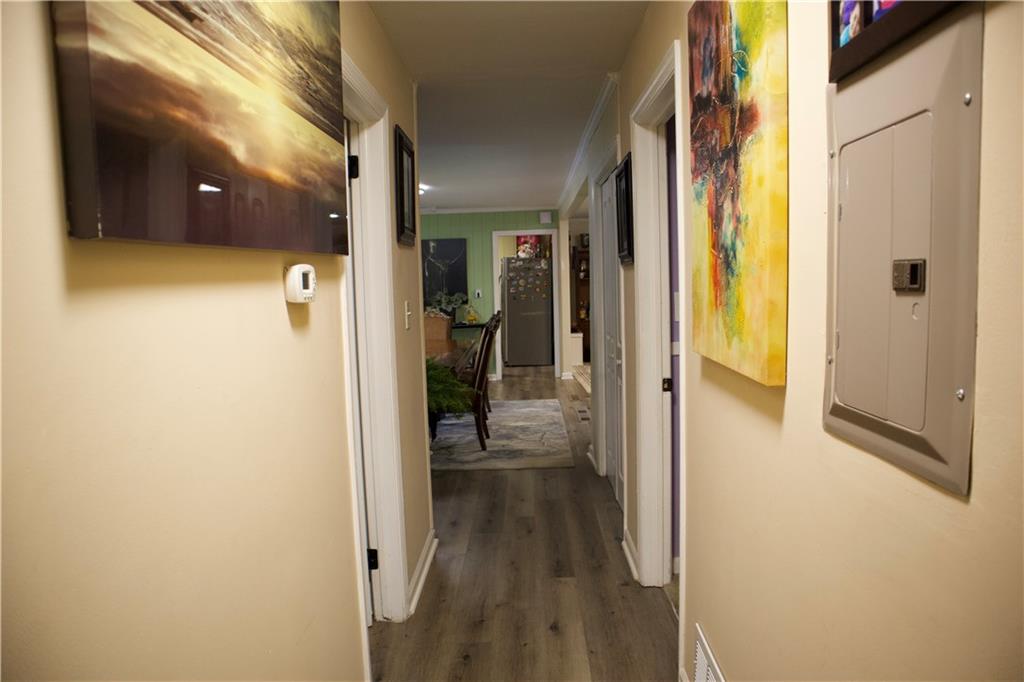 2586 Brandon Road Atlanta, GA 30337 - Photo 20 of 24 a view of a hallway with wooden floor and a living room