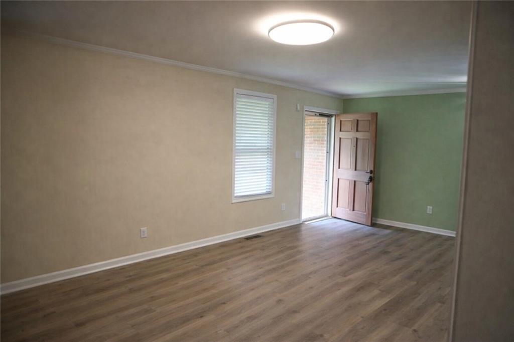 2586 Brandon Road Atlanta, GA 30337 - Photo 6 of 24 an empty room with wooden floor and windows