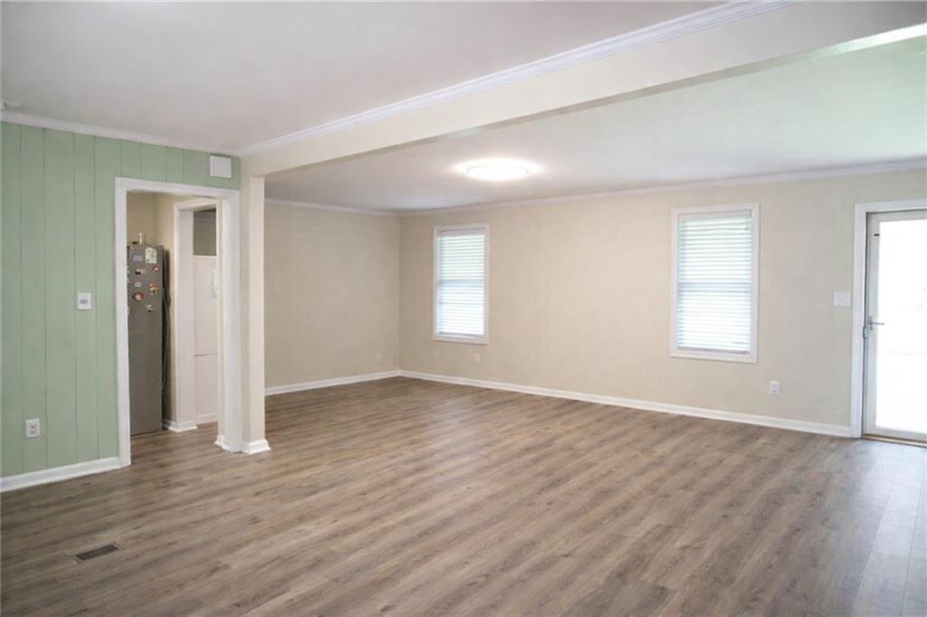 2586 Brandon Road Atlanta, GA 30337 - Photo 8 of 24 an empty room with wooden floor and windows