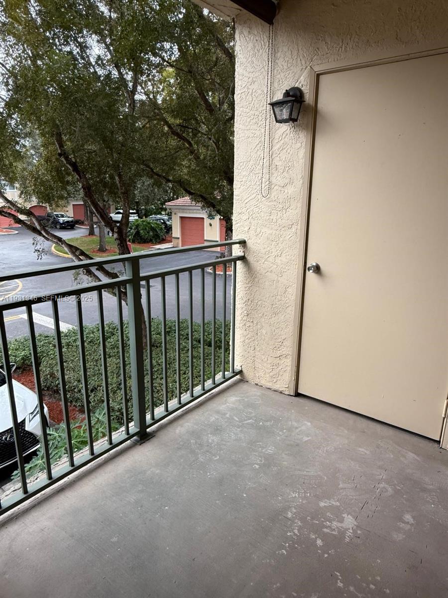 2494 Centergate Drive, Unit 201 Miramar, FL 33025 - Photo 11 of 20 a view of a balcony with wooden floor