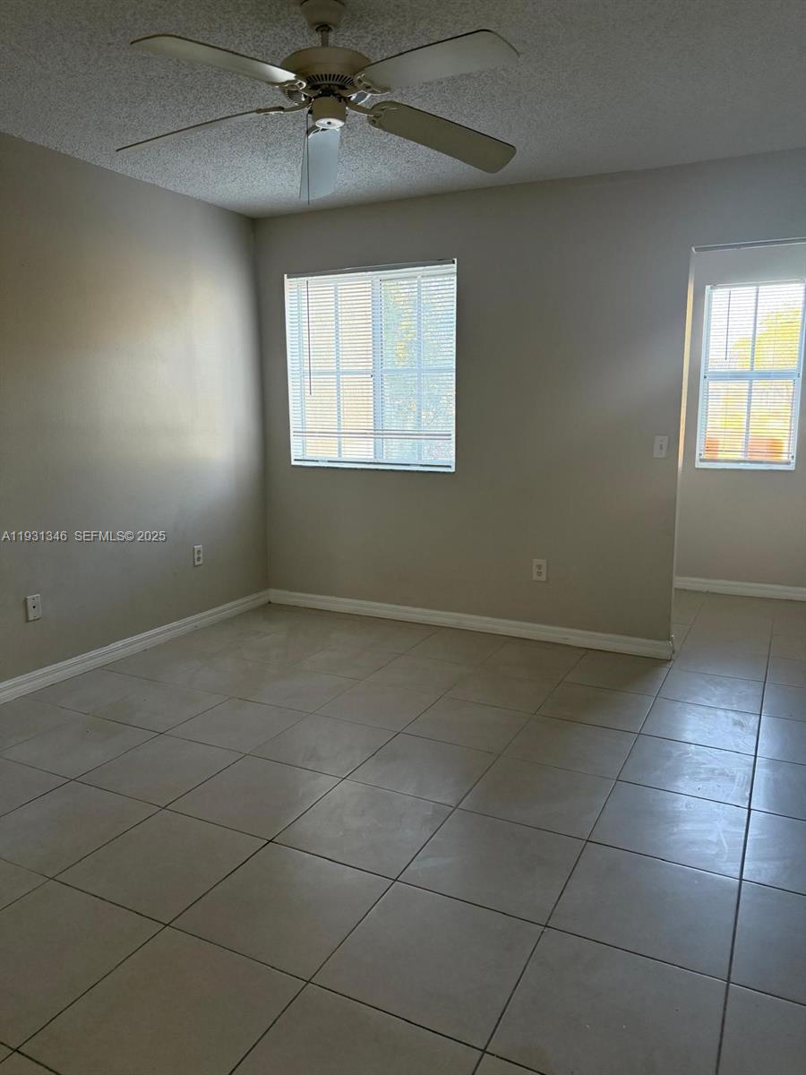 2494 Centergate Drive, Unit 201 Miramar, FL 33025 - Photo 15 of 20 an empty room with windows and fan