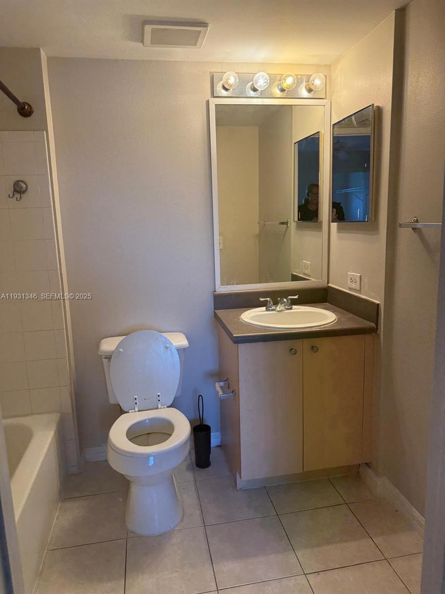 2494 Centergate Drive, Unit 201 Miramar, FL 33025 - Photo 16 of 20 a bathroom with a sink toilet and shower