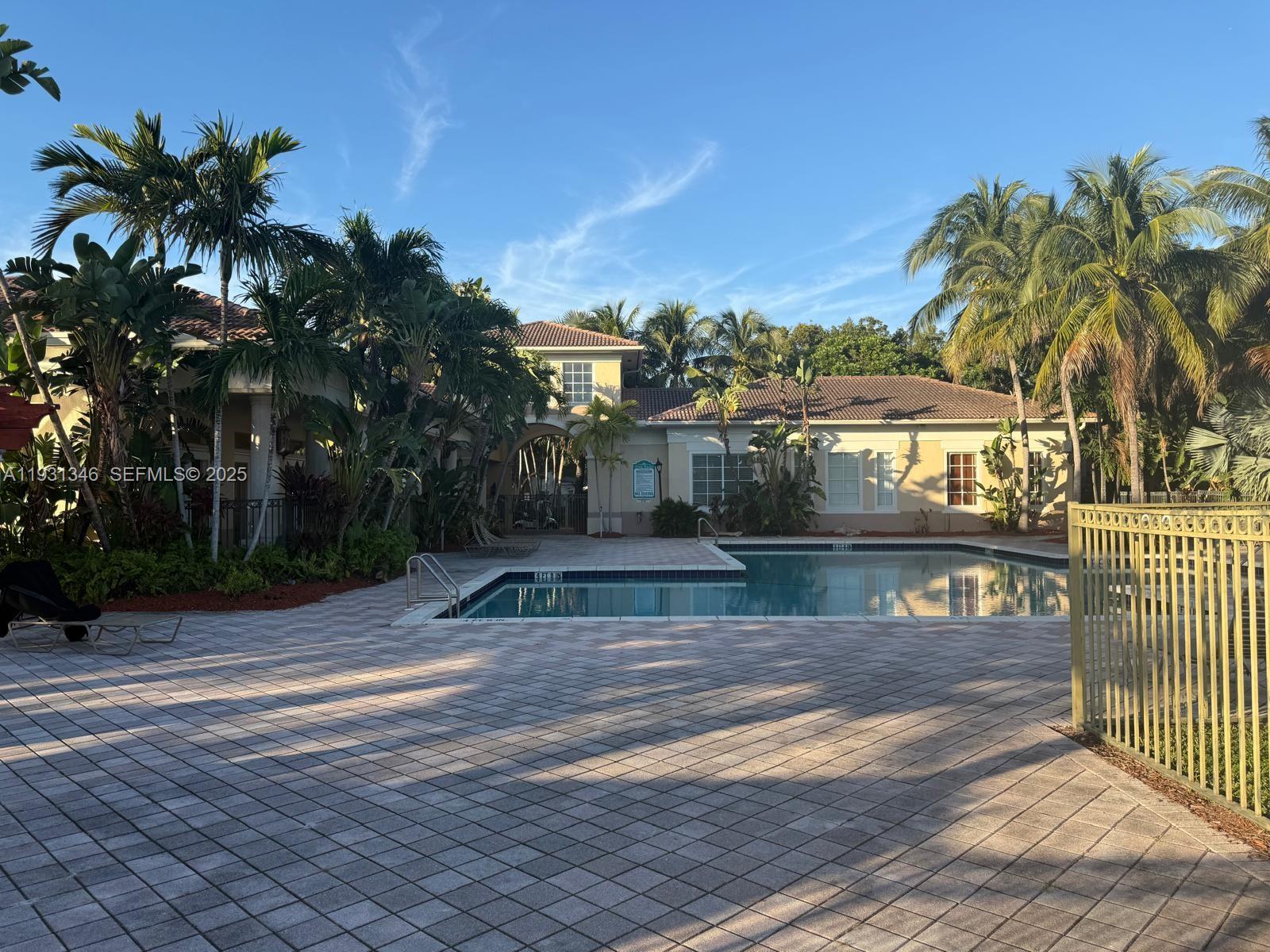 2494 Centergate Drive, Unit 201 Miramar, FL 33025 - Photo 18 of 20 a view of a yard and palm trees