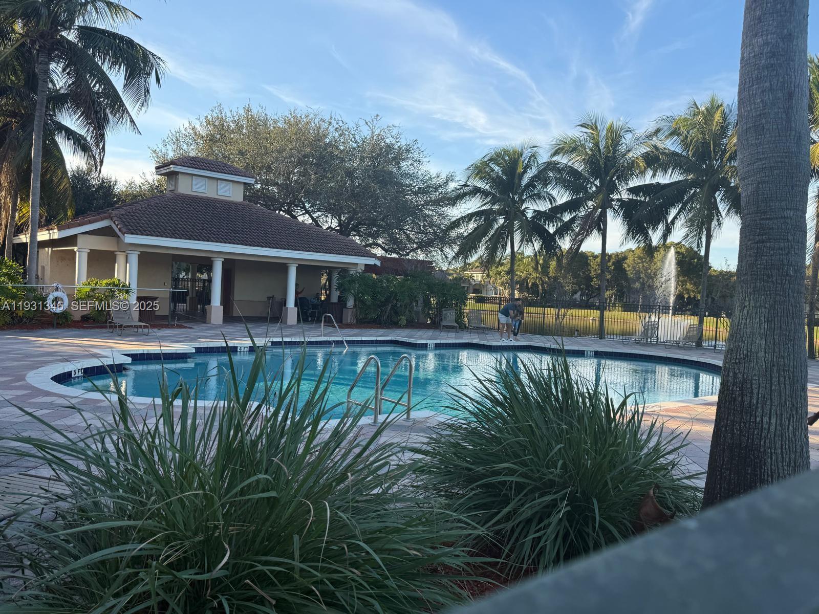 2494 Centergate Drive, Unit 201 Miramar, FL 33025 - Photo 19 of 20 a view of a swimming pool with a patio