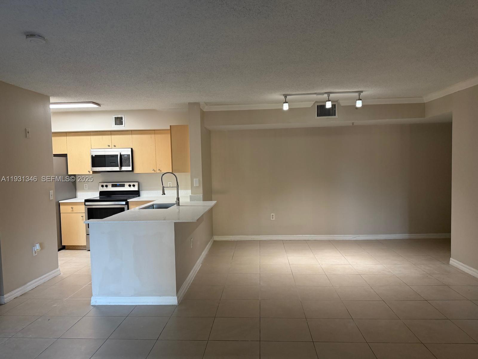 2494 Centergate Drive, Unit 201 Miramar, FL 33025 - Photo 4 of 20 a kitchen with a sink and cabinets