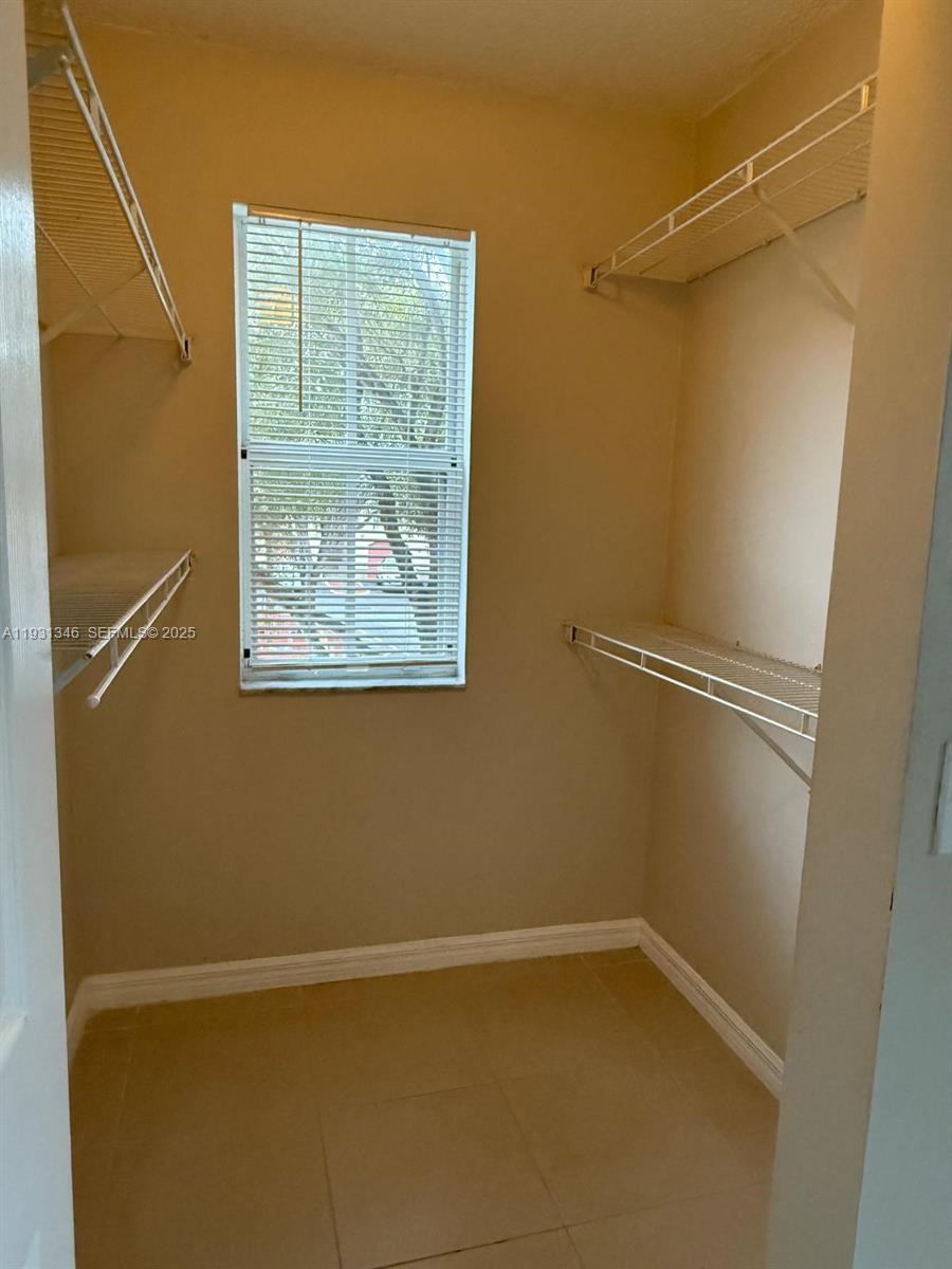 2494 Centergate Drive, Unit 201 Miramar, FL 33025 - Photo 10 of 20 a view of a small space with wooden floor and a window