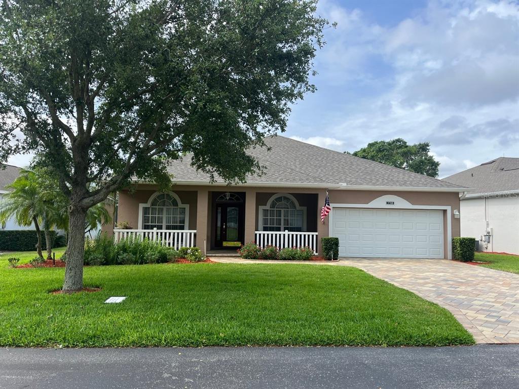 a front view of a house with yard and green space