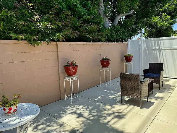 a backyard of a house with table and chairs