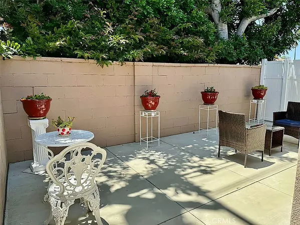 a view of a chairs and table in the backyard