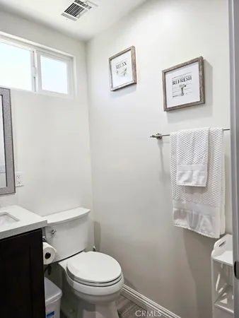 a white toilet sitting next to a bathroom sink