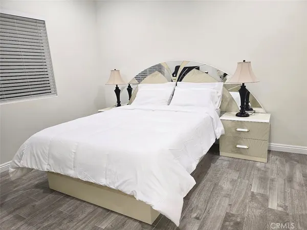 a bedroom with a bed and window