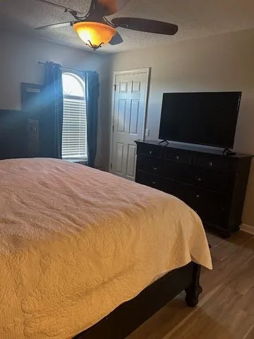 a bed sitting in a bedroom and bathroom