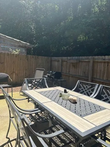 a view of a patio with table and chairs with wooden floor