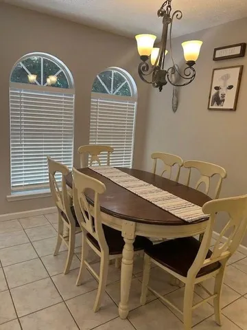 a view of a dining room with furniture and chandelier
