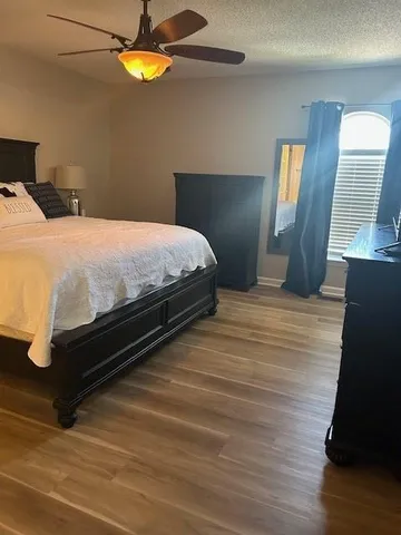 a bedroom with a bed and lamps