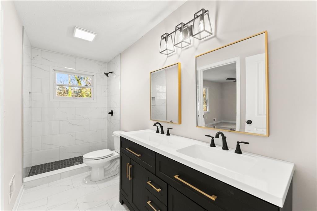 109 Tall Tree Road Athens, GA 30606 - Photo 12 of 33 a bathroom with a sink a toilet and a mirror