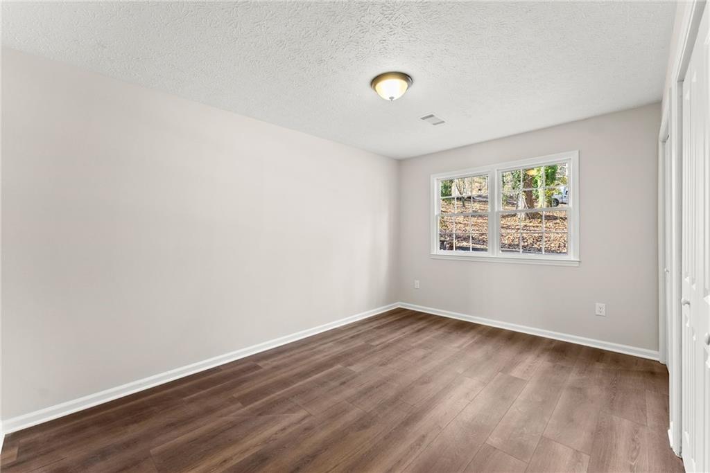 109 Tall Tree Road Athens, GA 30606 - Photo 23 of 33 an empty room with wooden floor and window