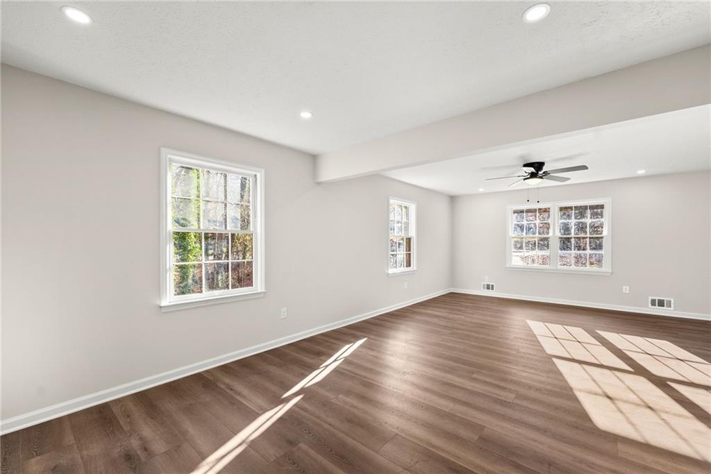109 Tall Tree Road Athens, GA 30606 - Photo 9 of 33 an empty room with wooden floor and windows
