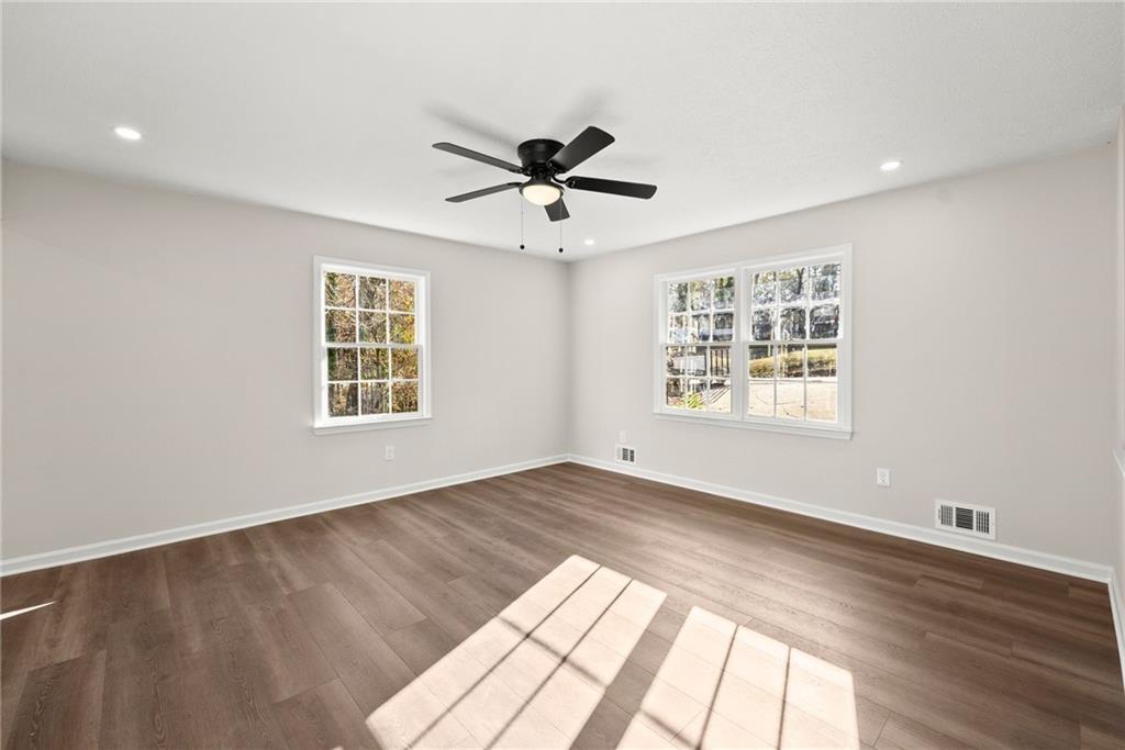 109 Tall Tree Road Athens, GA 30606 - Photo 10 of 33 a view of an empty room with a window and wooden floor