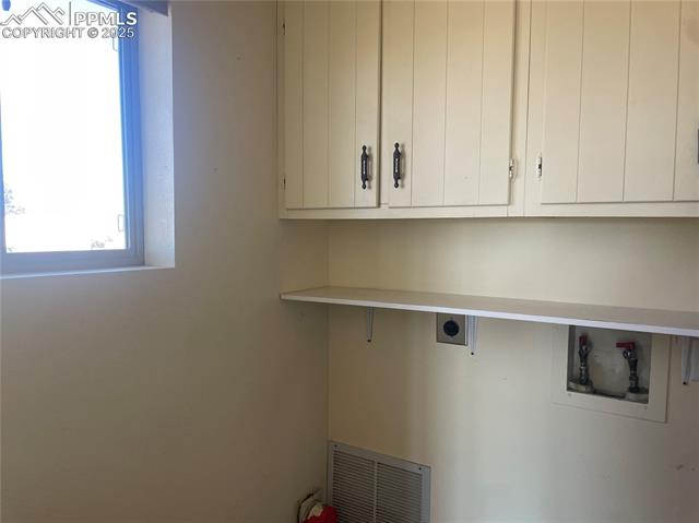 35 Diamond E Road Fountain, CO 80817 - Photo 8 of 27 Laundry is off the kitchen and features a window, cabinetry and shelving
